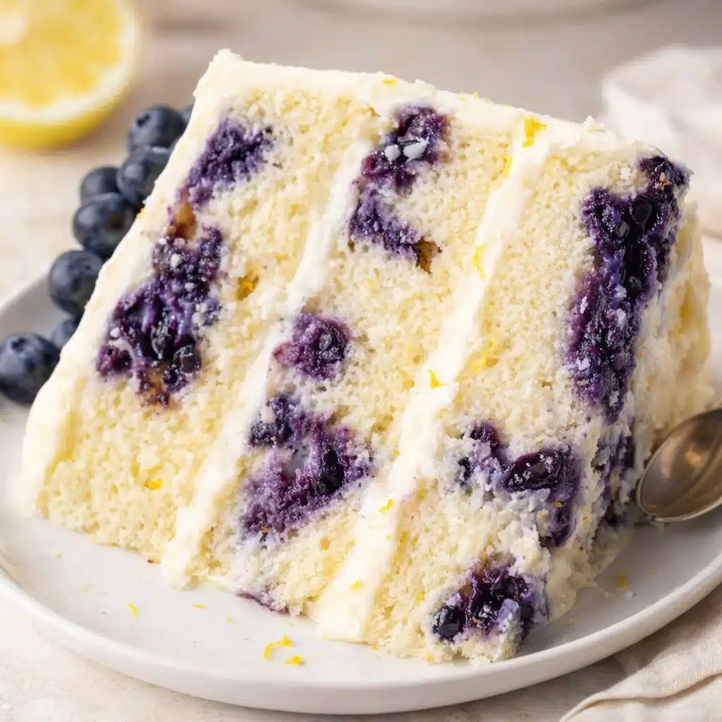Lemon Blueberry Cake Recipe 3 Lemon blueberry cake with fresh blueberries and lemon zest on a plate